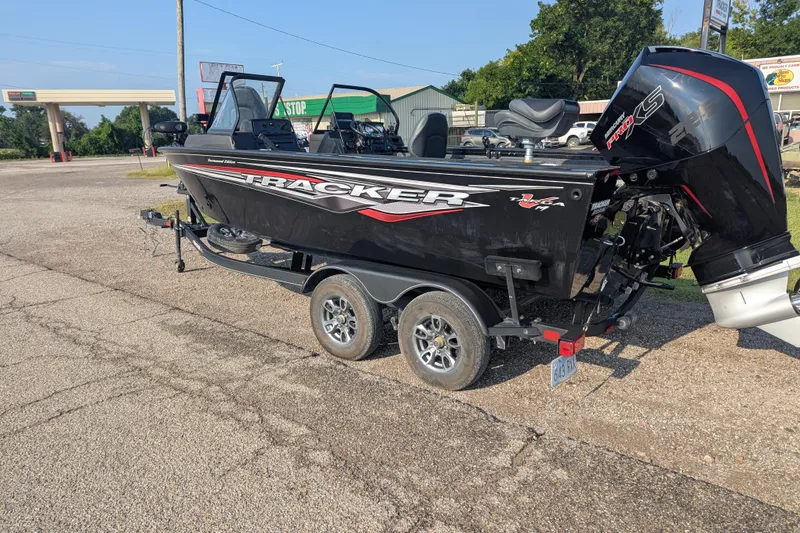 Slide: The Image of 2023 Tracker Targa V-19 Combo Tournament Edition boat on trailer in parking lot. - 3