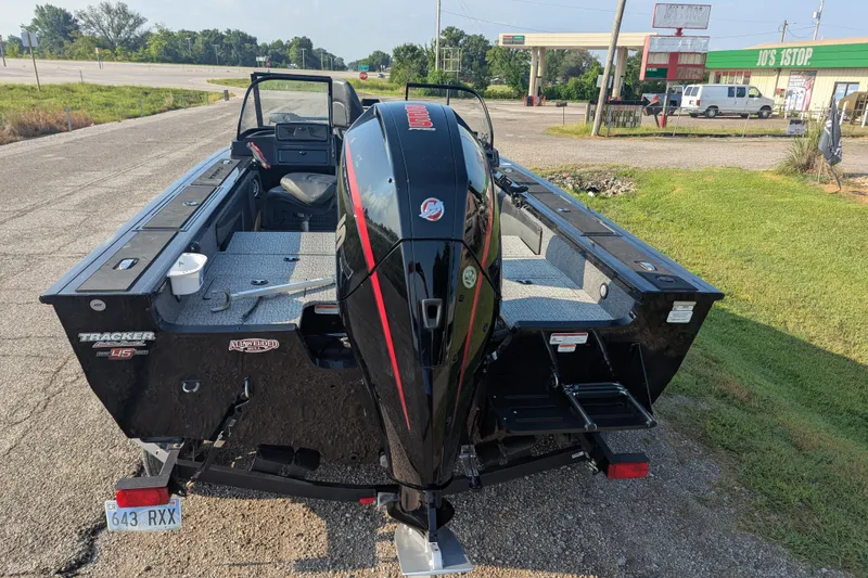 Slide: The Image of 2023 Tracker Targa V-19 Combo Tournament Edition boat on a trailer, parked near a roadside. - 5