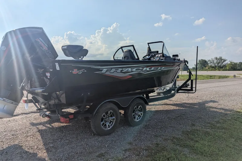 Slide: The Image of 2023 Tracker Targa V-19 Combo Tournament Edition boat on trailer, sunny day. - 8