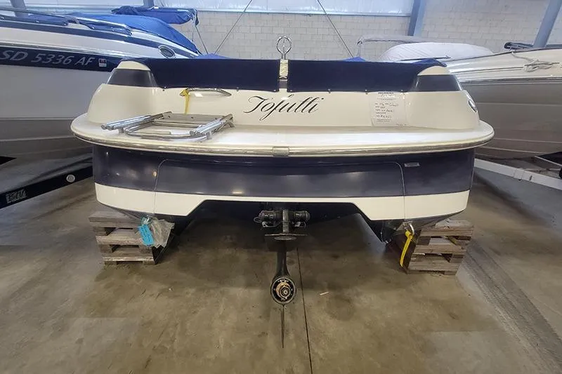 Slide: The Image of 1996 Cobalt 252 boat in storage, rear view, with "Tojulli" name displayed. - 3