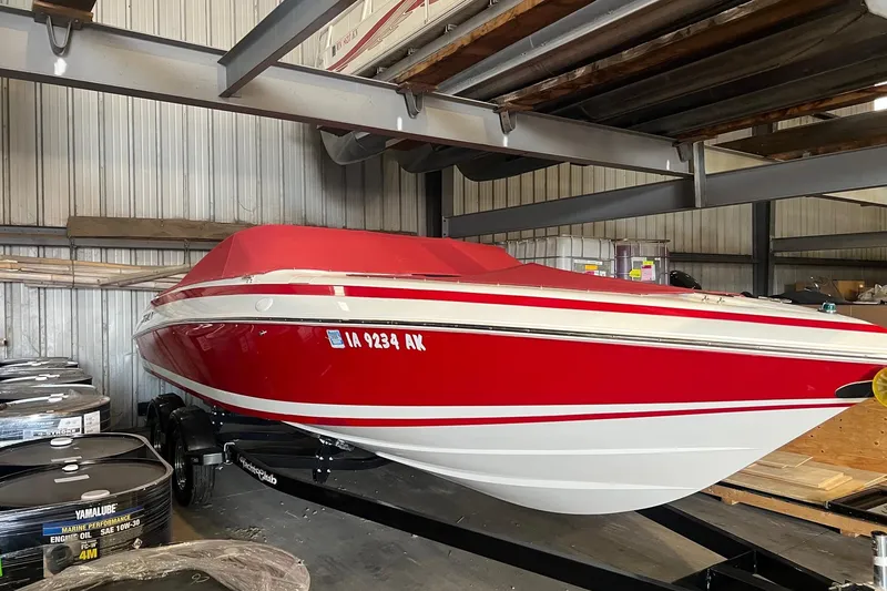 The Image of Red and white 1996 Cobalt 220 boat stored indoors on a trailer. - 1