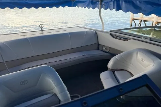 Slide: The Image of Interior of a 1996 Cobalt 220 boat with gray seating and blue canopy. - 3