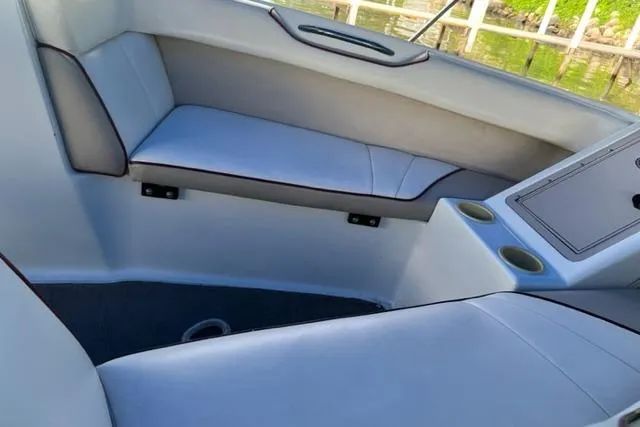 Slide: The Image of Interior of a 1996 Cobalt 220 boat with white seating and cup holders. - 4