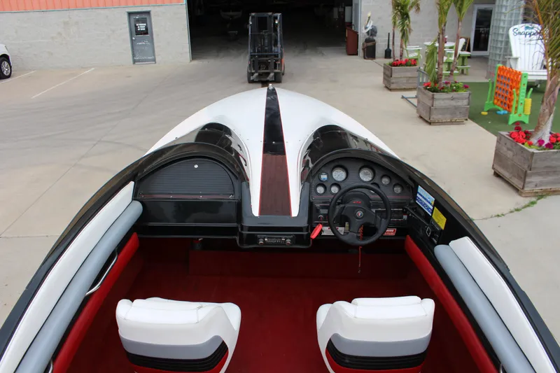 Slide: The Image of 1990 Wellcraft EXCALIBUR boat interior with white seats and dashboard, parked outdoors. - 4