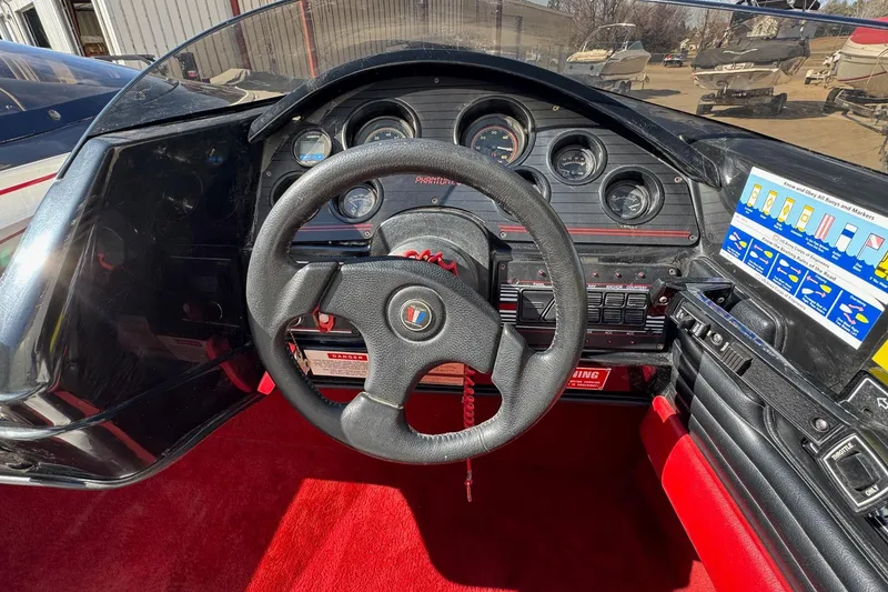 Slide: The Image of 1990 Wellcraft EXCALIBUR boat dashboard with steering wheel and instrument panel. - 6