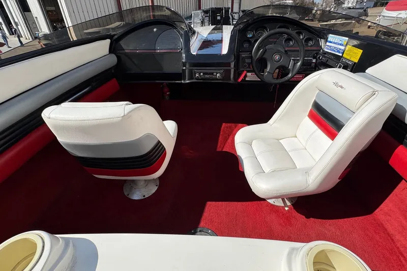 Slide: The Image of Interior of a 1990 Wellcraft EXCALIBUR boat with red carpet and white seats. - 7