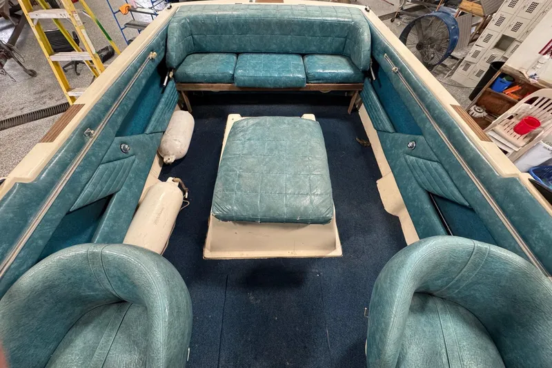 Slide: The Image of 1979 Chris-Craft Lancer 22 boat interior with teal seating and blue carpet. - 3