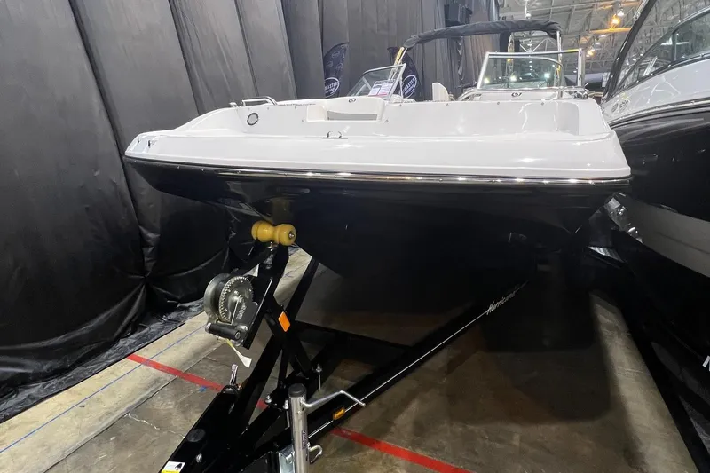 Slide: The Image of 2022 Hurricane SunDeck 187 IO boat displayed indoors on a trailer. - 3