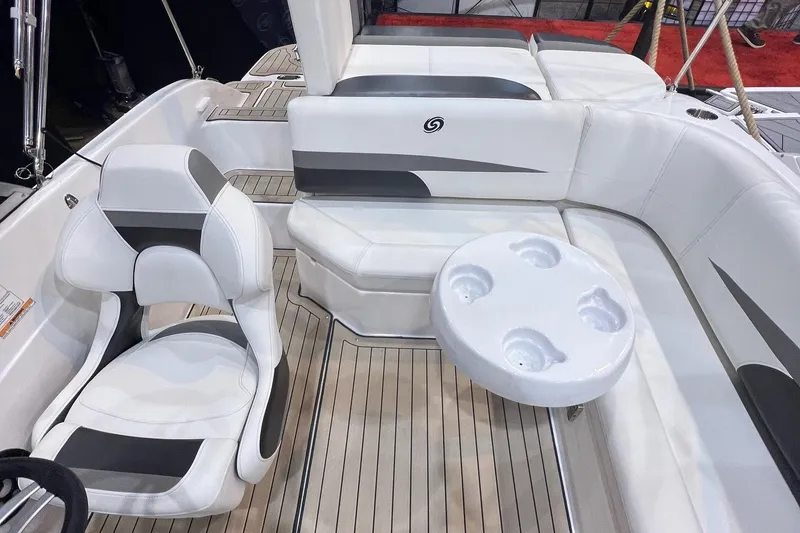 Slide: The Image of 2022 Hurricane SunDeck 187 IO boat interior with white seating and cupholder table. - 8