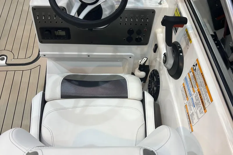 Slide: The Image of 2022 Hurricane SunDeck 187 IO boat cockpit with steering wheel and control panel. - 9