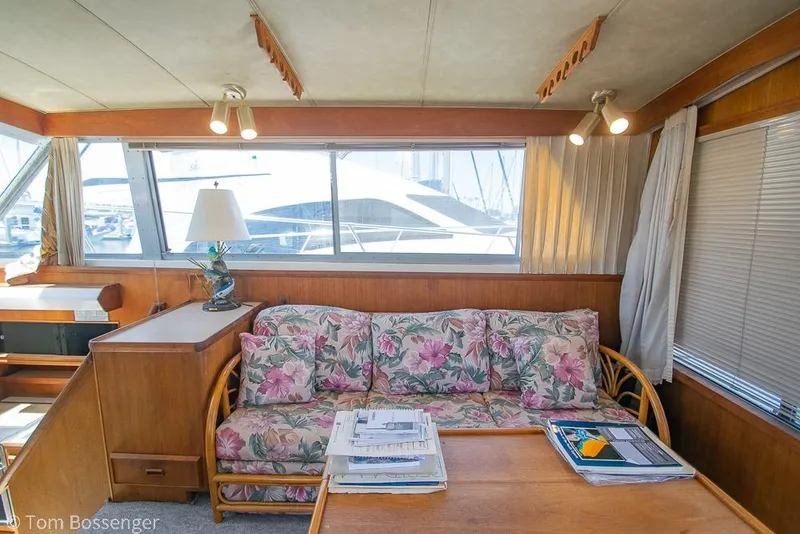 Slide: The Image of Interior of 1986 Bertram 42 Convertible with floral sofa and wooden furnishings. - 10