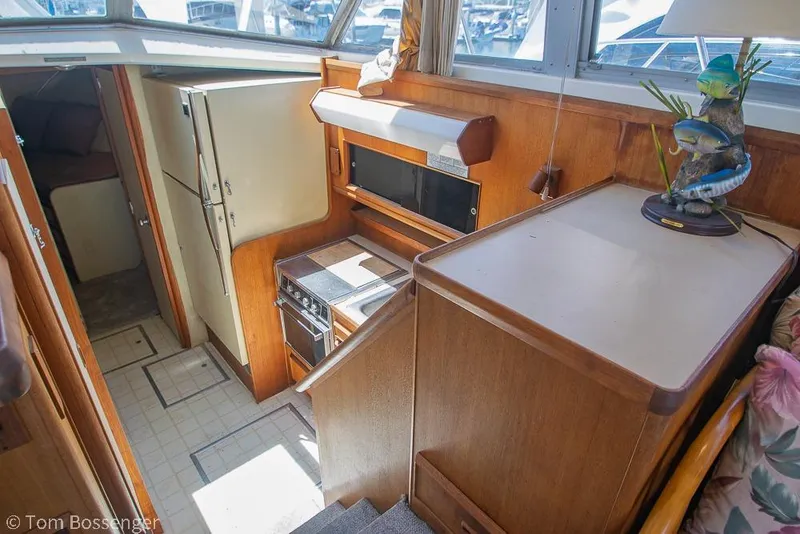 Slide: The Image of Interior of 1986 Bertram 42 Convertible yacht with kitchen and wooden cabinetry. - 14