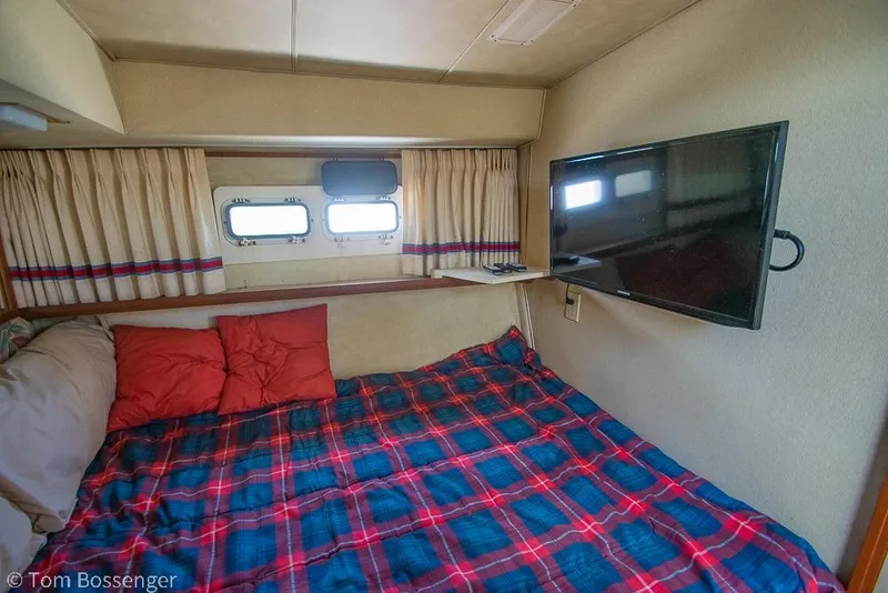 Slide: The Image of Cozy cabin interior of 1986 Bertram 42 Convertible with bed and mounted TV. - 19