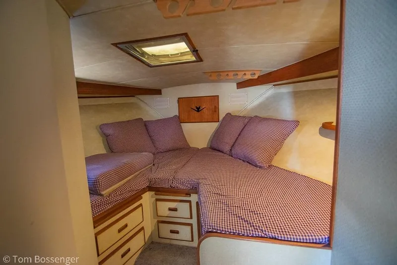 Slide: The Image of Cozy cabin interior of 1986 Bertram 42 Convertible with checkered bedding. - 20