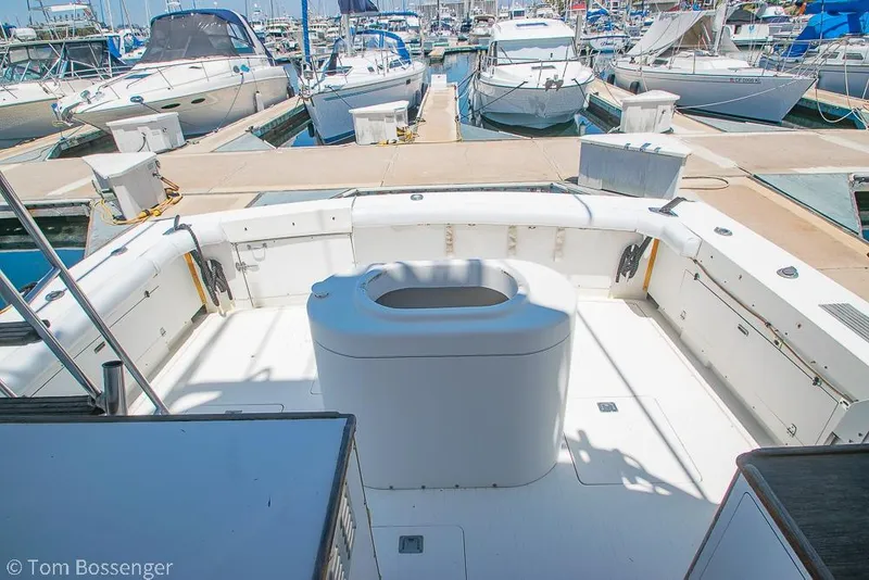 Slide: The Image of 1986 Bertram 42 Convertible yacht cockpit at marina, surrounded by boats. - 21