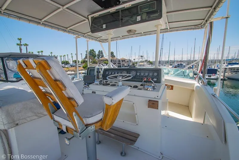 Slide: The Image of Helm of 1986 Bertram 42 Convertible yacht in marina setting. - 26