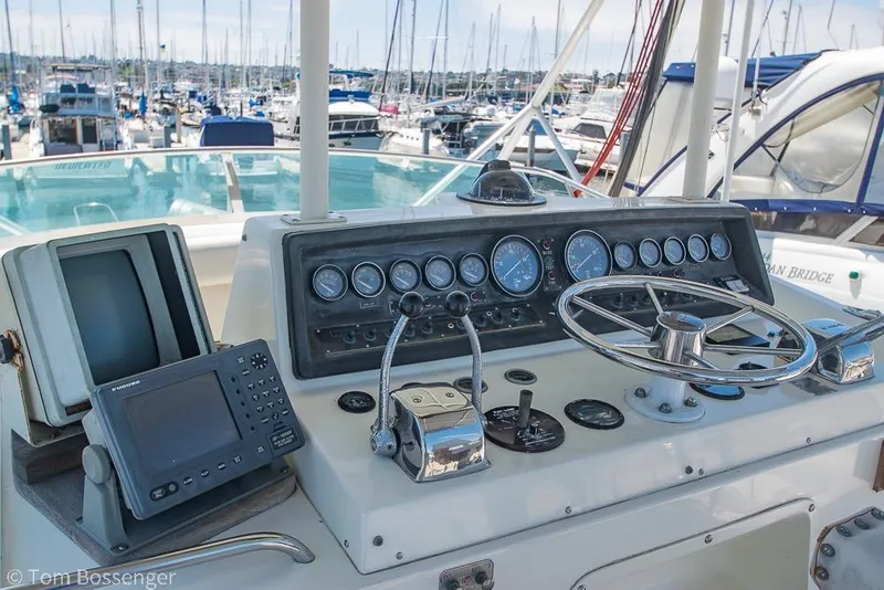 Slide: The Image of Control panel of a 1986 Bertram 42 Convertible yacht in a marina setting. - 30