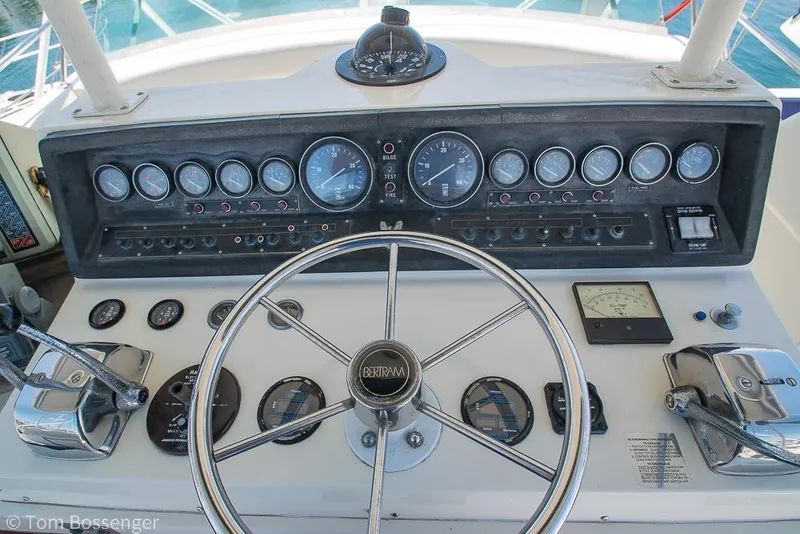 Slide: The Image of Control panel of a 1986 Bertram 42 Convertible yacht with steering wheel and gauges. - 31