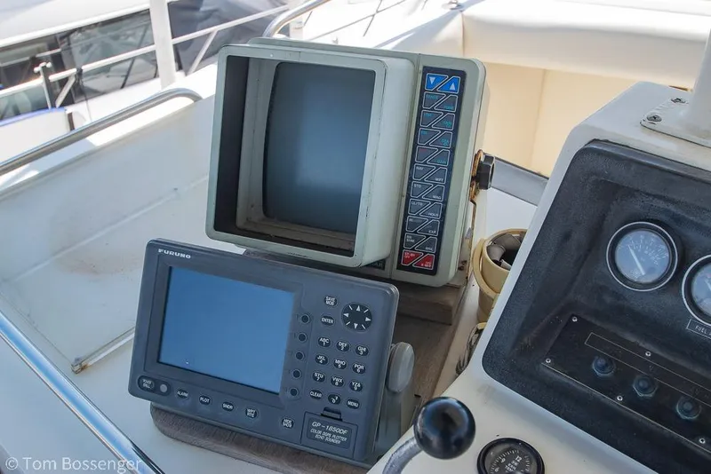 Slide: The Image of Control panel of a 1986 Bertram 42 Convertible boat with navigation equipment. - 32