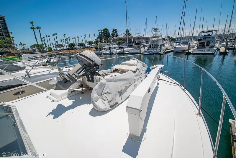 Slide: The Image of 1986 Bertram 42 Convertible yacht docked in a marina with clear blue skies. - 37