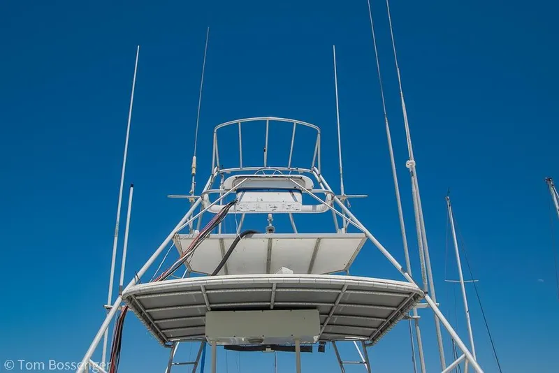 Slide: The Image of 1986 Bertram 42 Convertible boat tower against clear blue sky. - 38