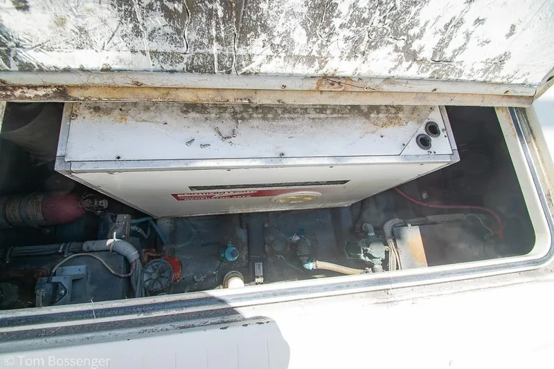 Slide: The Image of Engine compartment of 1986 Bertram 42 Convertible boat, showing machinery and components. - 43