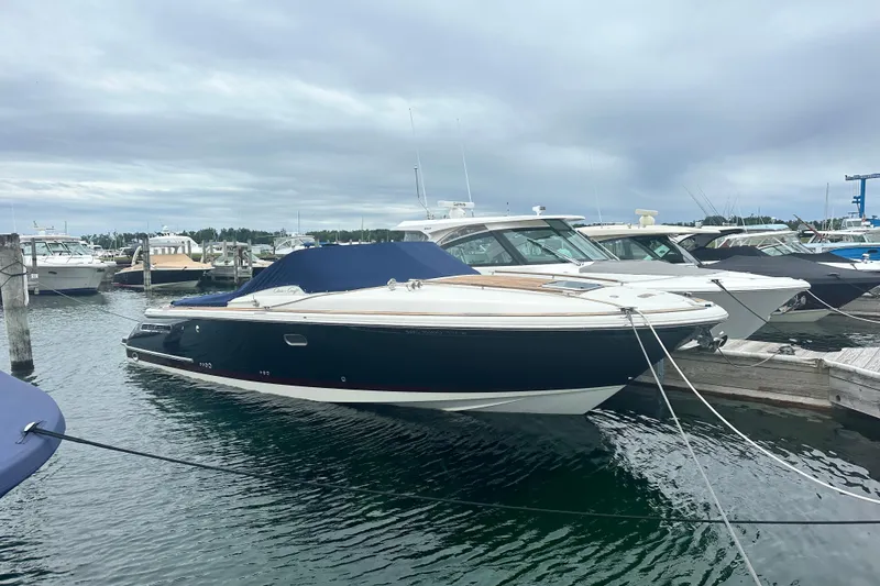 Slide: The Image of 2007 Chris-Craft Corsair 33 Heritage Edition docked at marina under cloudy sky. - 1