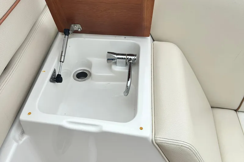 Slide: The Image of 2007 Chris-Craft Corsair 33 Heritage Edition boat sink with chrome faucet and wooden cover. - 10