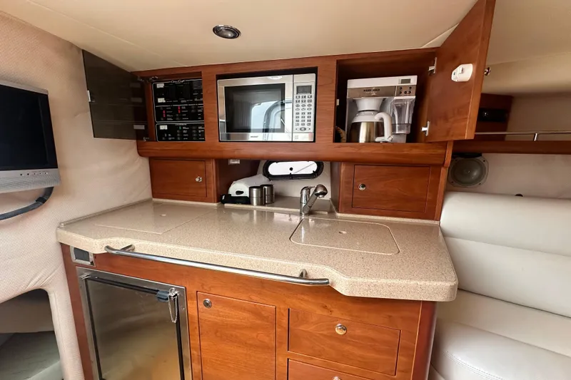 Slide: The Image of 2007 Chris-Craft Corsair 33 Heritage Edition galley with microwave, sink, and coffee maker. - 19