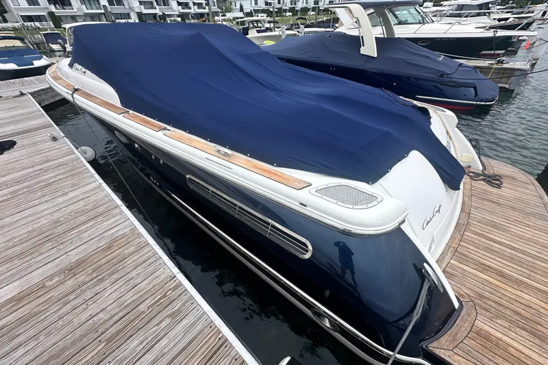 Slide: The Image of 2007 Chris-Craft Corsair 33 Heritage Edition boat docked with blue cover. - 2