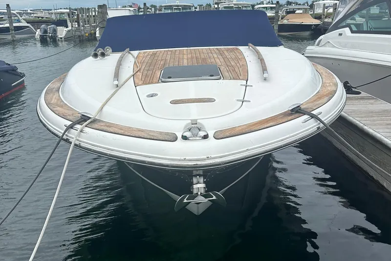 Slide: The Image of 2007 Chris-Craft Corsair 33 Heritage Edition docked, showcasing elegant wooden deck details. - 3