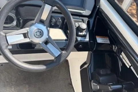 Slide: The Image of 2020 Yamaha AR240 boat cockpit with steering wheel and control panel. - 10