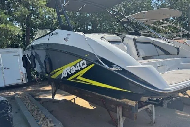 Slide: The Image of 2020 Yamaha Boats AR240 on trailer, sleek design with bold graphics, parked outdoors. - 3