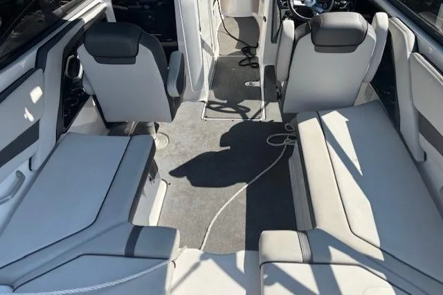 Slide: The Image of 2020 Yamaha Boats AR240 interior with gray seating and carpeted floor. - 9