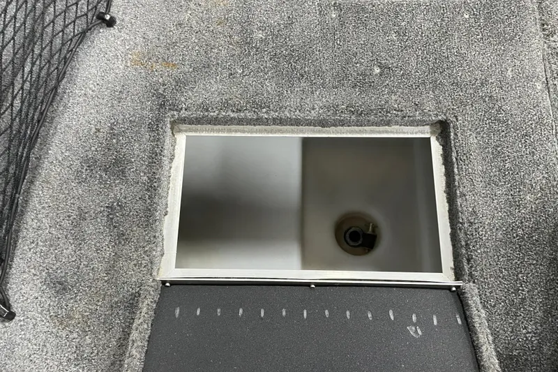 Slide: The Image of 2014 Crestliner 1750 Fish Hawk livewell with open lid on carpeted deck. - 18