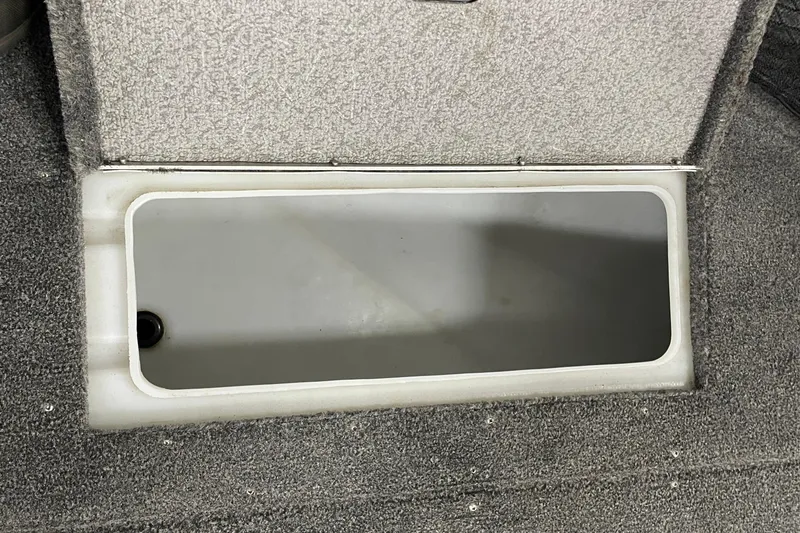 Slide: The Image of 2014 Crestliner 1750 Fish Hawk livewell with open lid, showcasing interior storage space. - 19