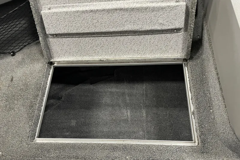 Slide: The Image of Open storage compartment in 2014 Crestliner 1750 Fish Hawk boat, carpeted interior. - 20