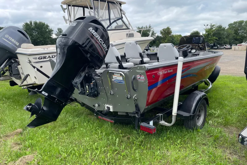Slide: The Image of 2014 Crestliner 1750 Fish Hawk boat with Mercury engine on grassy area. - 22
