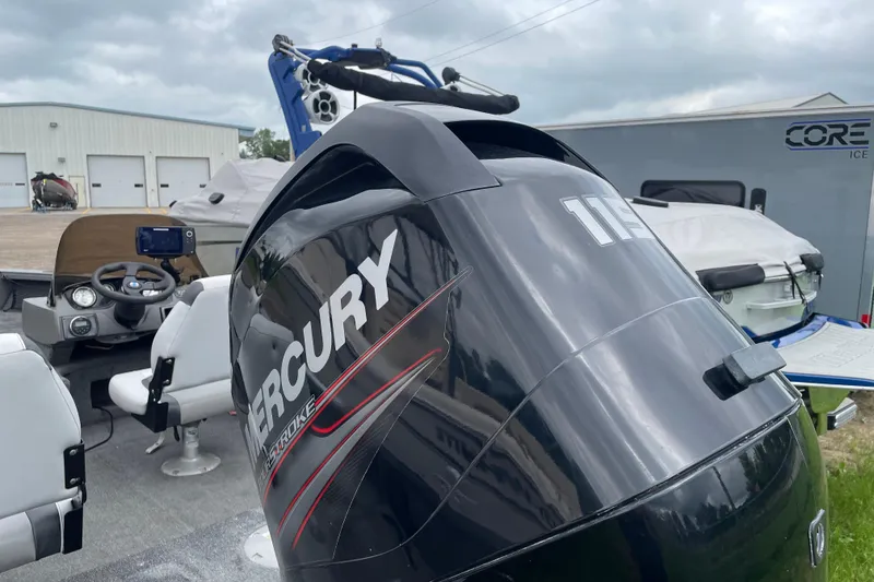 Slide: The Image of 2014 Crestliner 1750 Fish Hawk with Mercury outboard motor, parked outdoors. - 24