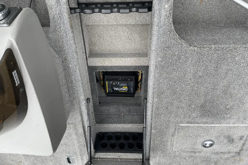 Slide: The Image of 2014 Crestliner 1750 Fish Hawk interior with digital equipment and storage compartments. - 33