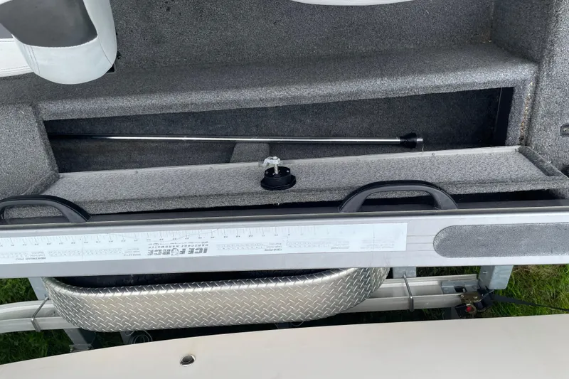 Slide: The Image of 2014 Crestliner 1750 Fish Hawk interior with storage compartment and measuring ruler. - 38