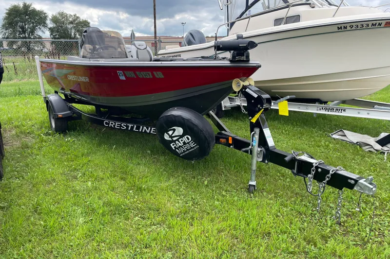 Slide: The Image of 2014 Crestliner 1750 Fish Hawk boat on trailer, parked on grass. - 4
