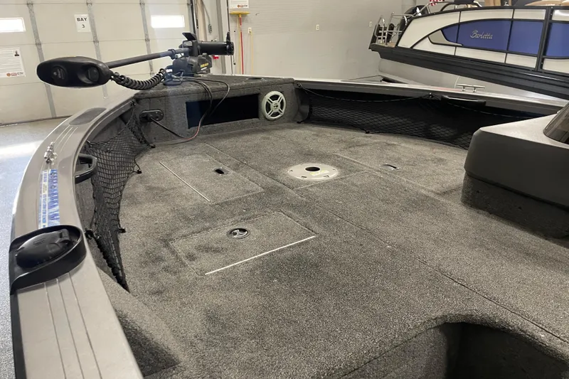 Slide: The Image of 2014 Crestliner 1750 Fish Hawk boat interior with trolling motor and spacious deck. - 5