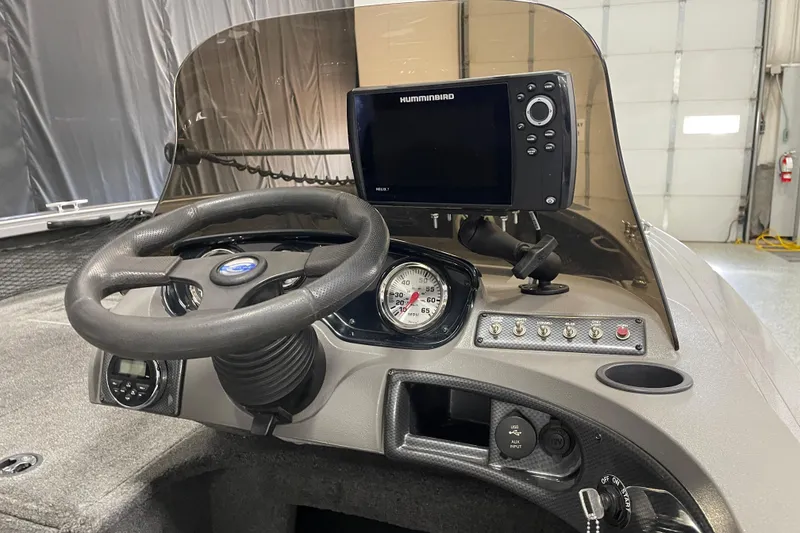 Slide: The Image of Dashboard of 2014 Crestliner 1750 Fish Hawk with steering wheel and Humminbird fish finder. - 9