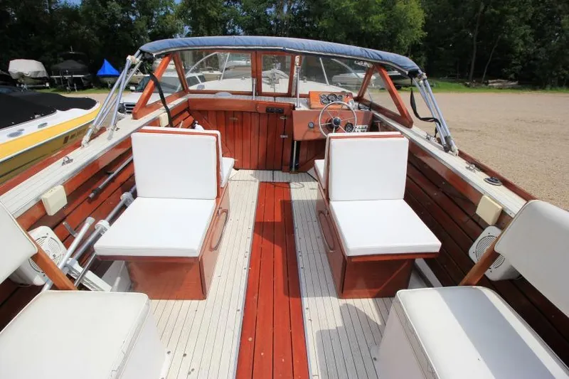 Slide: The Image of 1963 Thompson Skiff Craft 21 boat interior with wooden finish and white seating. - 10