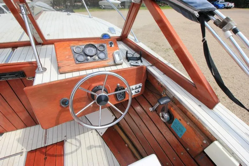 Slide: The Image of 1963 Thompson Skiff Craft 21 boat interior with wooden dashboard and steering wheel. - 12