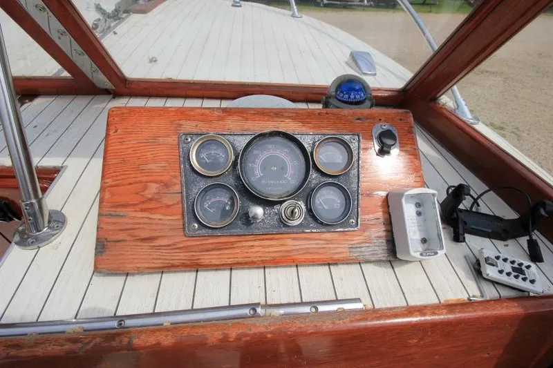 Slide: The Image of 1963 Thompson Skiff Craft 21 dashboard with vintage gauges and wooden paneling. - 13