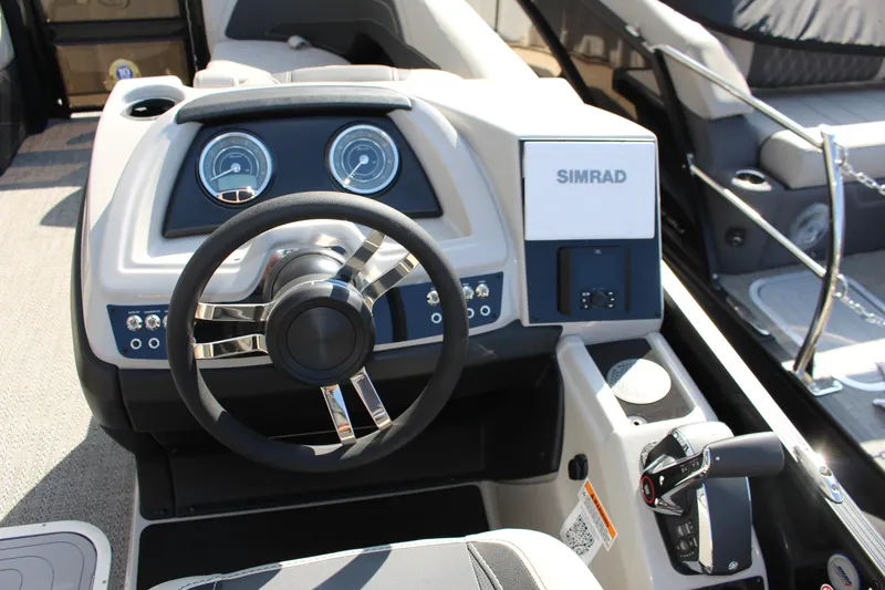 Slide: The Image of 2026 Barletta Cabrio 22QC boat dashboard with steering wheel and Simrad display. - 12