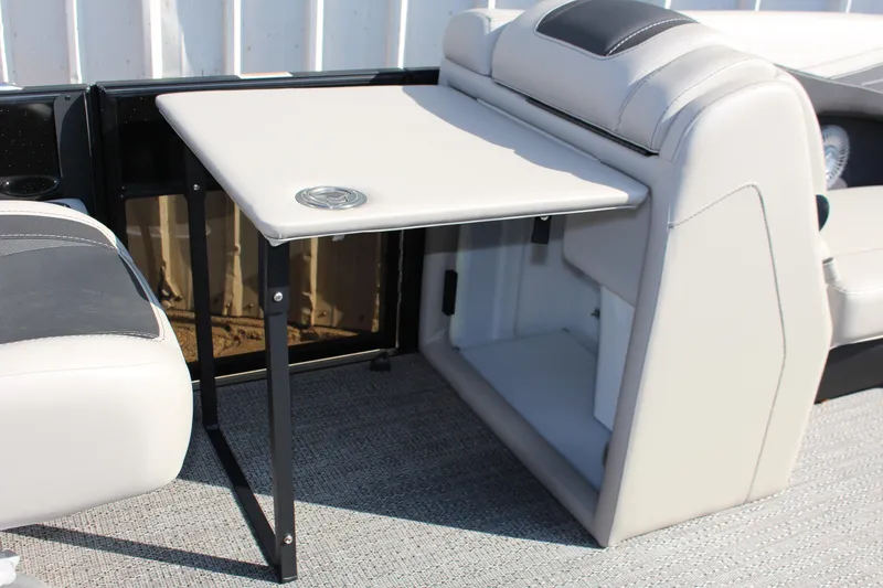 Slide: The Image of Barletta Cabrio 22QC 2026 boat interior with foldable table and seating. - 16