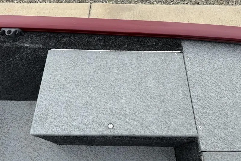 Slide: The Image of 2019 Tracker Pro 170 boat interior with gray textured flooring and red trim. - 11